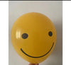 Yellow balloon with a smiley face design on a plain background