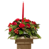 red flowers and winter greens and christmas decor and candle