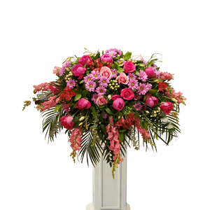 pink theme casket spray. peony, roses, daisy, snapdragon and seasonal flowers