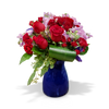 Elegant floral arrangement featuring vibrant red roses and soft lilac blooms, accented with lush greenery in a striking blue vase. A perfect gift for romantic occasions, anniversaries, or special celebrations, available at Chez Joy Florist.