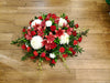 casket spray red and white theme. lily, mum and roses with best seasonal flowers